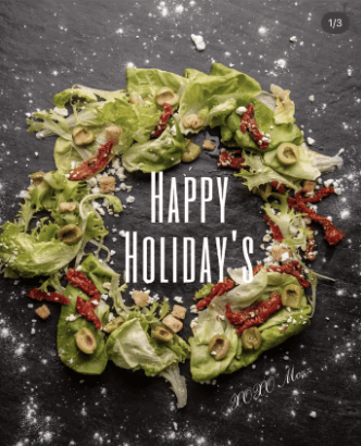 A wreath-shaped salad with "Happy Holiday's" text overlaid